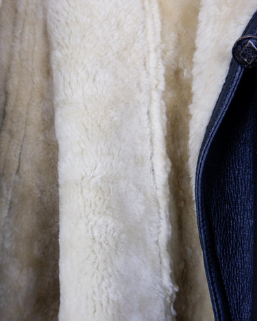 Wrap yourself in cozy luxury with this Premium Vintage 80s black leather shearling coat. This timeless coat has all the bells and whistles for an edgy winter look with maximum comfort! Ready for all that cold-weather fun in this coat?