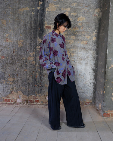 1980s vintage silk blouse with a loose fit and floral print in burgundy-violet on taupe. The silk adds a natural sense of luxury and ease. A laid-back piece with quiet elegance and vintage character.
