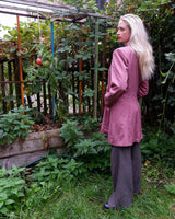 This vintage blazer in a striking dark pink is a must-have for any fashion-forward individual. Its long fit and two rows of buttons add a unique twist to any outfit. Whether you're dressing up for a formal event or adding some flair to your everyday look, this blazer has got you covered. (No time for boring fashion here!)