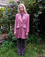 This vintage blazer in a striking dark pink is a must-have for any fashion-forward individual. Its long fit and two rows of buttons add a unique twist to any outfit. Whether you're dressing up for a formal event or adding some flair to your everyday look, this blazer has got you covered. (No time for boring fashion here!)