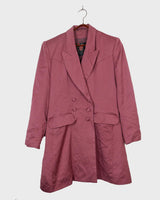 This vintage blazer in a striking dark pink is a must-have for any fashion-forward individual. Its long fit and two rows of buttons add a unique twist to any outfit. Whether you're dressing up for a formal event or adding some flair to your everyday look, this blazer has got you covered. (No time for boring fashion here!)