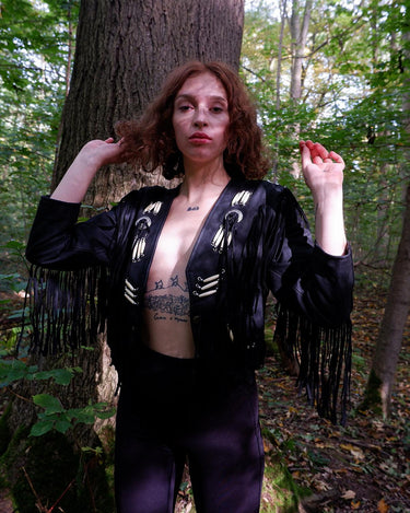 Unleash your inner rebel with this vintage 80s black leather crop fringe jacket. Made from high-quality leather, this XS jacket features fringe detailing that will make a statement. 