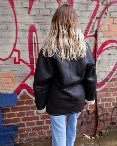 Wrap yourself in cozy luxury with this Premium Vintage 80s black leather shearling coat. This timeless coat has all the bells and whistles for an edgy winter look with maximum comfort! Ready for all that cold-weather fun in this coat?