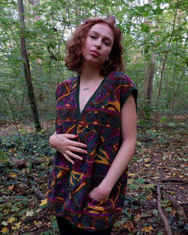 Wrap yourself in quirky, vintage charm with our colorful 80s fleece vest! Featuring a fun, pattern-filled design, this XL vest will keep you cozy in style. 