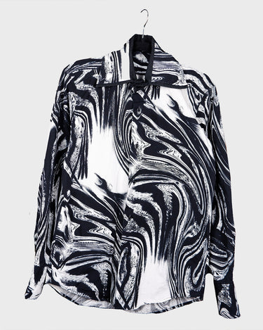 This black and white shirt doesn’t ask for attention — it just gets it. The abstract swirl pattern gives effortless chaos in the best way possible. Throw it on and let the print do the talking!