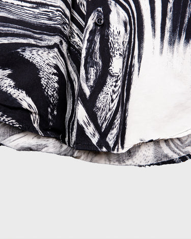 This black and white shirt doesn’t ask for attention — it just gets it. The abstract swirl pattern gives effortless chaos in the best way possible. Throw it on and let the print do the talking!