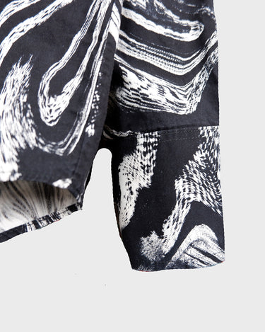This black and white shirt doesn’t ask for attention — it just gets it. The abstract swirl pattern gives effortless chaos in the best way possible. Throw it on and let the print do the talking!