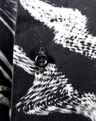 This black and white shirt doesn’t ask for attention — it just gets it. The abstract swirl pattern gives effortless chaos in the best way possible. Throw it on and let the print do the talking!