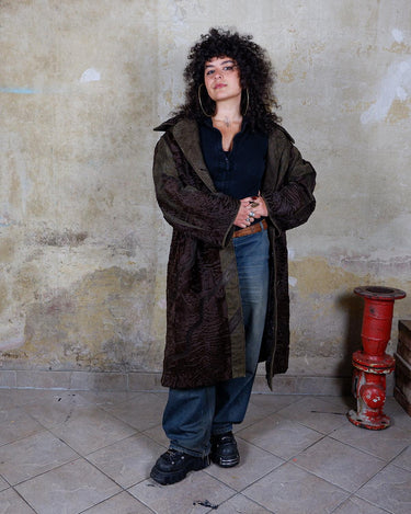 Add a touch of eccentricity to your wardrobe with this vintage 80s long brown leather fur coat. Featuring unique patchwork leather and a cozy fur lining, this XL-XXL coat is perfect for making a bold statement