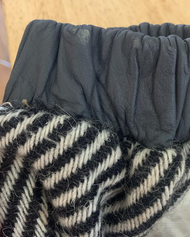 Own a piece of classic 80s style with this eye-catching vintage grey striped jacket! Crafted from a vegan leather and wool mix, it's got a deep cut and a belt to give it that extra special something. (Note: Definitely one of my favourite jackets so far)