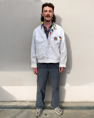 This vintage Missoni Sport windbreaker from the 90s is a standout piece with its bold striped accents and iconic globe logo embroidery. Made in Italy and cut in a comfortable size L, it offers a relaxed fit and lightweight feel – ideal for everyday wear. A rare example of Missoni’s sporty aesthetic, combining timeless design with a splash of color. Effortlessly cool and easy to style.