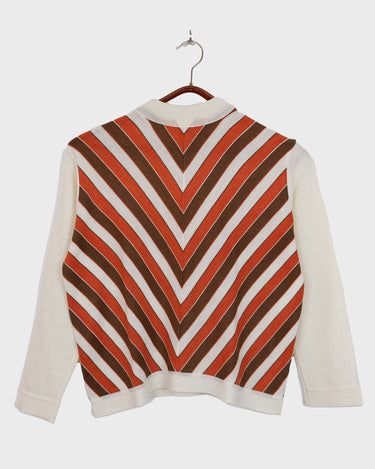 This vintage 70s turtleneck sweater by Rossi Gold features a chevron pattern in burnt orange, chocolate brown and white. Made from a lightweight knit, its a true statement piece for anyone embracing the 70s.