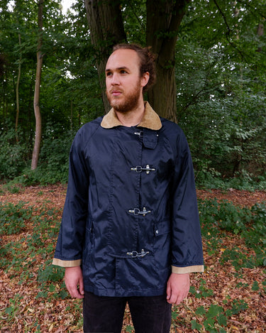 a man is wearing a Vintage 80s 90s lightweight navy blue fireman clasp jacket with corduroy collar size L-XL from the online shop vinti vintage