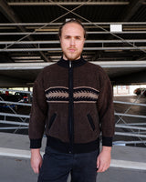 Looking to add a timeless vintage piece to your wardrobe? This original 80s zip-up knit jacket features a rich brown tone with black accents and a bold geometric stripe across the chest. The thick ribbed texture and relaxed fit deliver effortless old-school cool with a cozy feel.