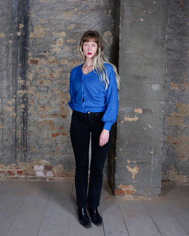 Authentic 1980s vintage cardigan in electric blue with a bold split-knit design - smooth on one side, open crochet on the other. The color is loud, the texture is cool, and the fit feels effortlessly comfortable. A rare vintage piece for people who don’t do boring.