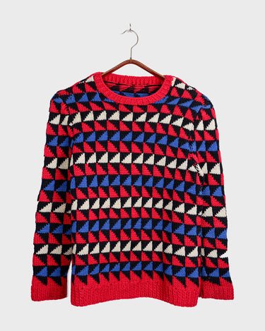 Wrap yourself in cozyness with this vintage 80s handknitted wool sweater! Featuring a geometric pattern in red, white, and blue, it’s designed to fit XS-S sizes perfectly. Cozy, colorful and full of character!