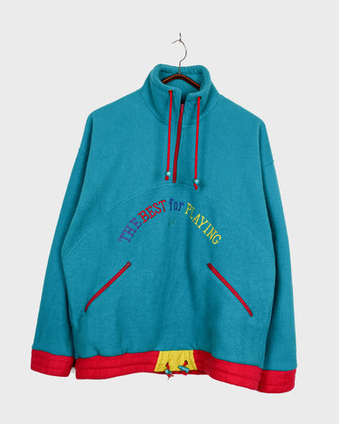 This vintage 90s PUMA half-zip is a certified vintage gem with serious color personality. Turquoise meets red and yellow in a bold colorblock design that refuses to blend in, while cheeky multicolor embroidered "The Best for Playing" lettering adds character. The subtle chest logo keeps it grounded. This fleece delivers comfort wrapped