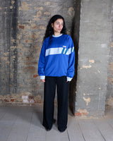 This vintage 90s Samar sweatshirt features a bold royal blue colorway with a light blue horizontal stripe and subtle teal accent details for a classic sporty look. Made in the 1990s, it showcases the iconic color-block sportswear style that defines authentic vintage streetwear.