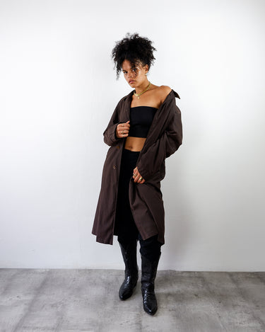 a woman is wearing a Y2k schneiders salzburg brown trench coat with removable plaid lining | M-L from the online shop vinti vintage