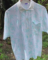 Sun’s out, button up! This Italian vintage white polo shirt brings serious 80s energy with its sharp button-up neckline and eye-catching turquoise pattern. A rare vintage gem that’s equal parts sporty, stylish, and a little cheeky. Wear it loud, wear it proud – this polo’s got main character energy.