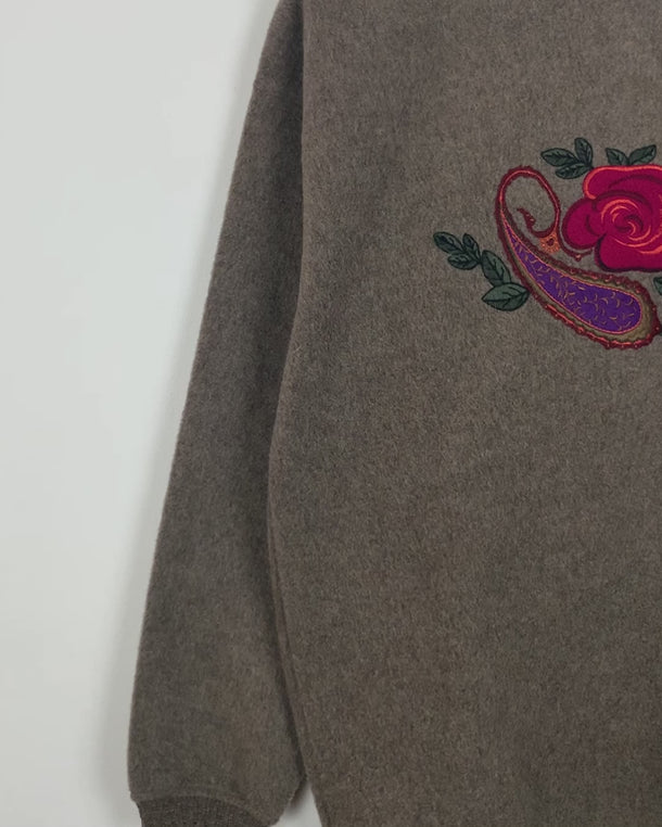 Get cozy in this Vintage 80s brown sweater, complete with beautiful floral stitching. Perfect for chilly days, this sweater is the ultimate way to stay snug. Cozyness is calling!