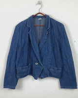 Indulge in your love for denim with this vintage 80s two rows blazer in classic blue. A must-have for any denim enthusiast, this jacket is a timeless addition to your wardrobe.