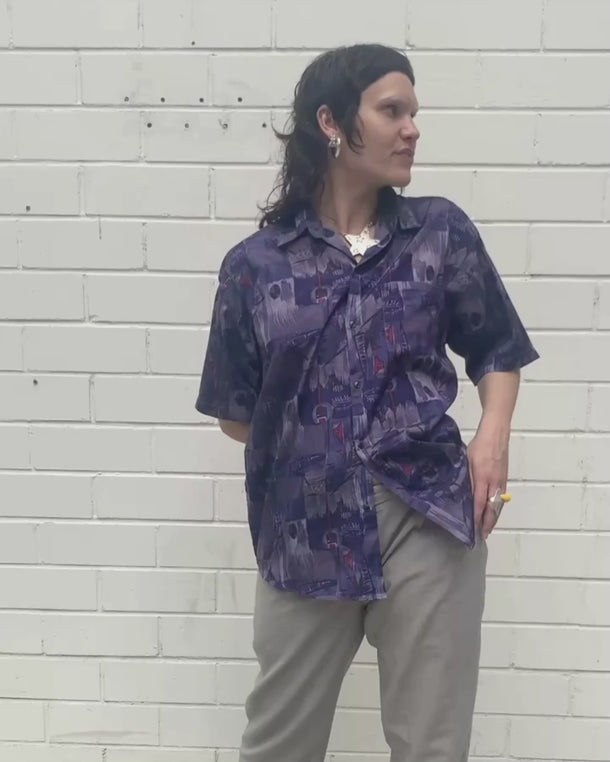 Bold, breezy, and silky smooth - this rare 90s short-sleeve gem by T. Corner is made from real Thai silk, brought to you by one of Thailand’s most renowned silk producers. The glossy fabric pops with a crazy pattern in electric purples and blues that’s impossible to ignore. Wear it loud, wear it proud