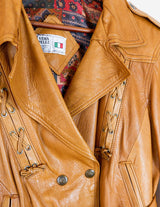 a woman is wearing a brown leather jacket.
