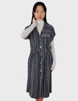 a woman is wearing a 90s vintage striped belted midi dress.