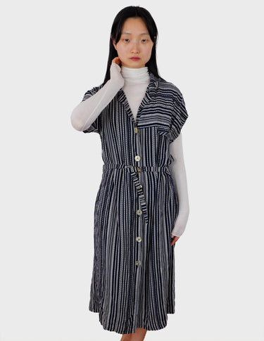 a woman is wearing a 90s vintage striped belted midi dress.