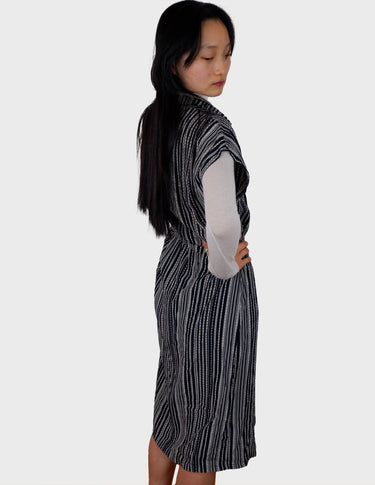 a woman is wearing a 90s vintage striped belted midi dress.