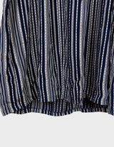 a woman is wearing a 90s vintage striped belted midi dress.