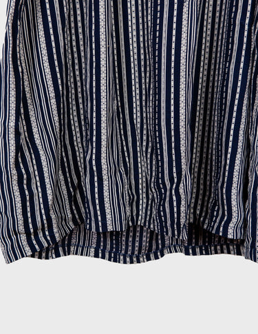 a woman is wearing a 90s vintage striped belted midi dress.