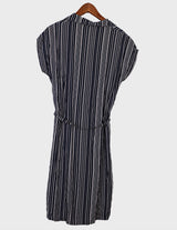 a woman is wearing a 90s vintage striped belted midi dress.