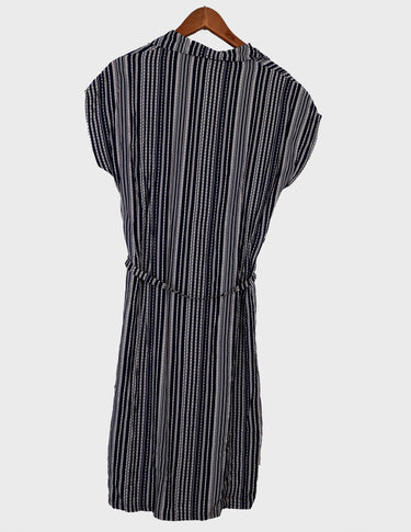 a woman is wearing a 90s vintage striped belted midi dress.