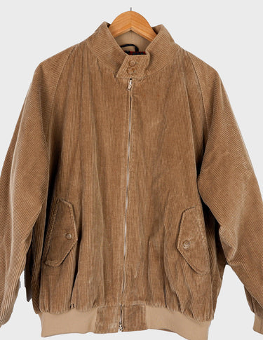 a woman is wearing a brown vintage bomber cord jacket.