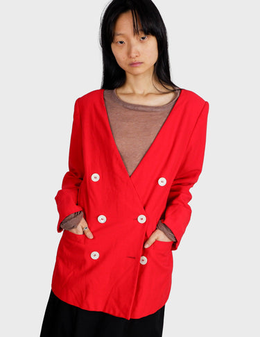 a woman is wearing a red 80s vintage blazer.