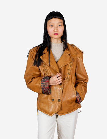 a woman is wearing a brown leather jacket.