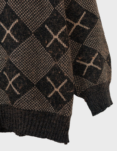 a woman is wearing a 80s brown vintage abstract pattern sweater.