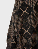a woman is wearing a 80s brown vintage abstract pattern sweater.