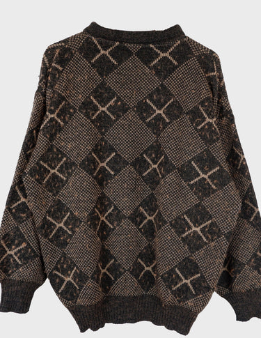 a woman is wearing a 80s brown vintage abstract pattern sweater.
