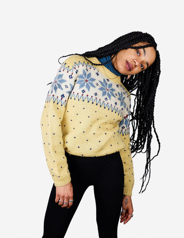 a woman is wearing a yellow sweater.
