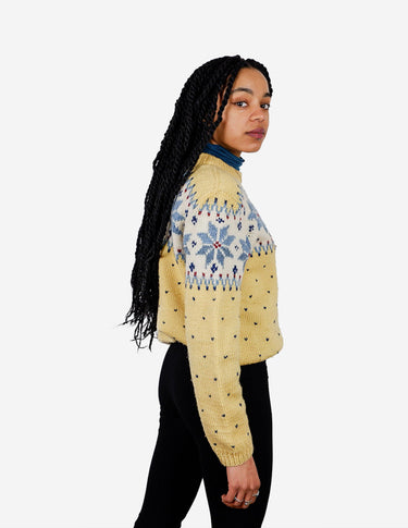 a woman is wearing a yellow sweater.