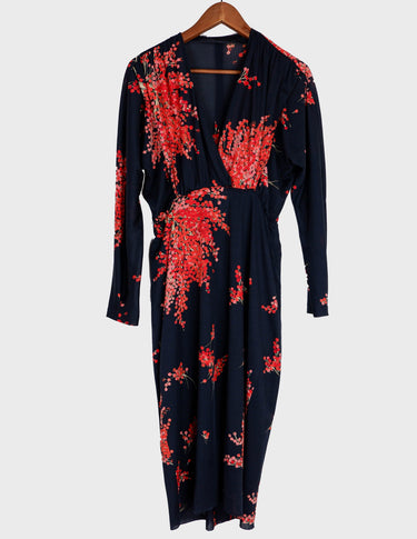 a woman with blonde hair is wearing a vintage 80s 90s floral maxi dress.