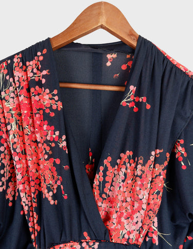 a woman with blonde hair is wearing a vintage 80s 90s floral maxi dress.