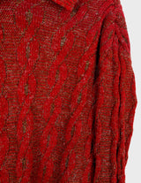 a woman isi wearing a vintage 90s cable knit sweater.
