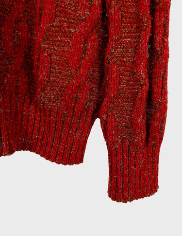 a woman isi wearing a vintage 90s cable knit sweater.