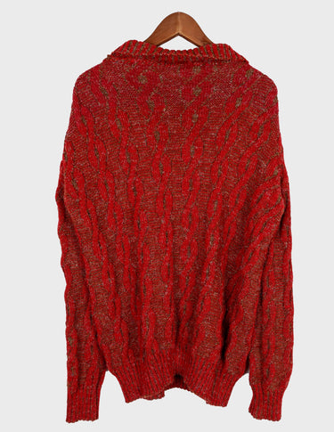 a woman isi wearing a vintage 90s cable knit sweater.